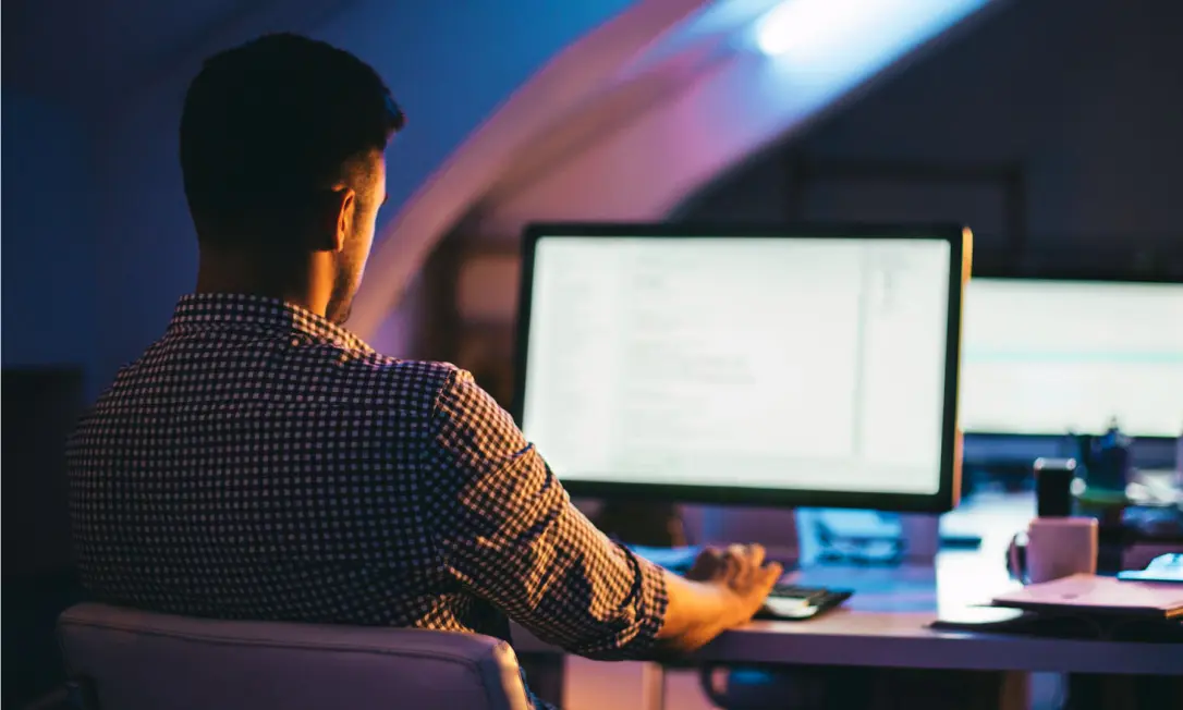 A man works at his computer, using Dashlane Smart Extension in his chosen browser.