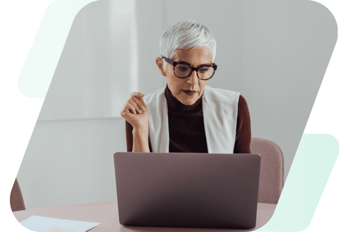 This image shows a woman working on her laptop with light green and gradient dashes behind the image.