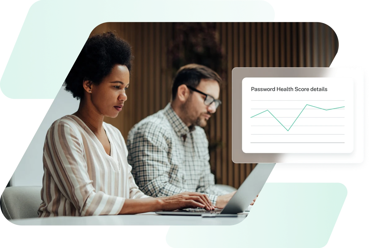 This image shows a man and a woman working at a shared desk with product imagery of Dashlane’s Password Health score, representing how Dashlane provides enterprise password management.