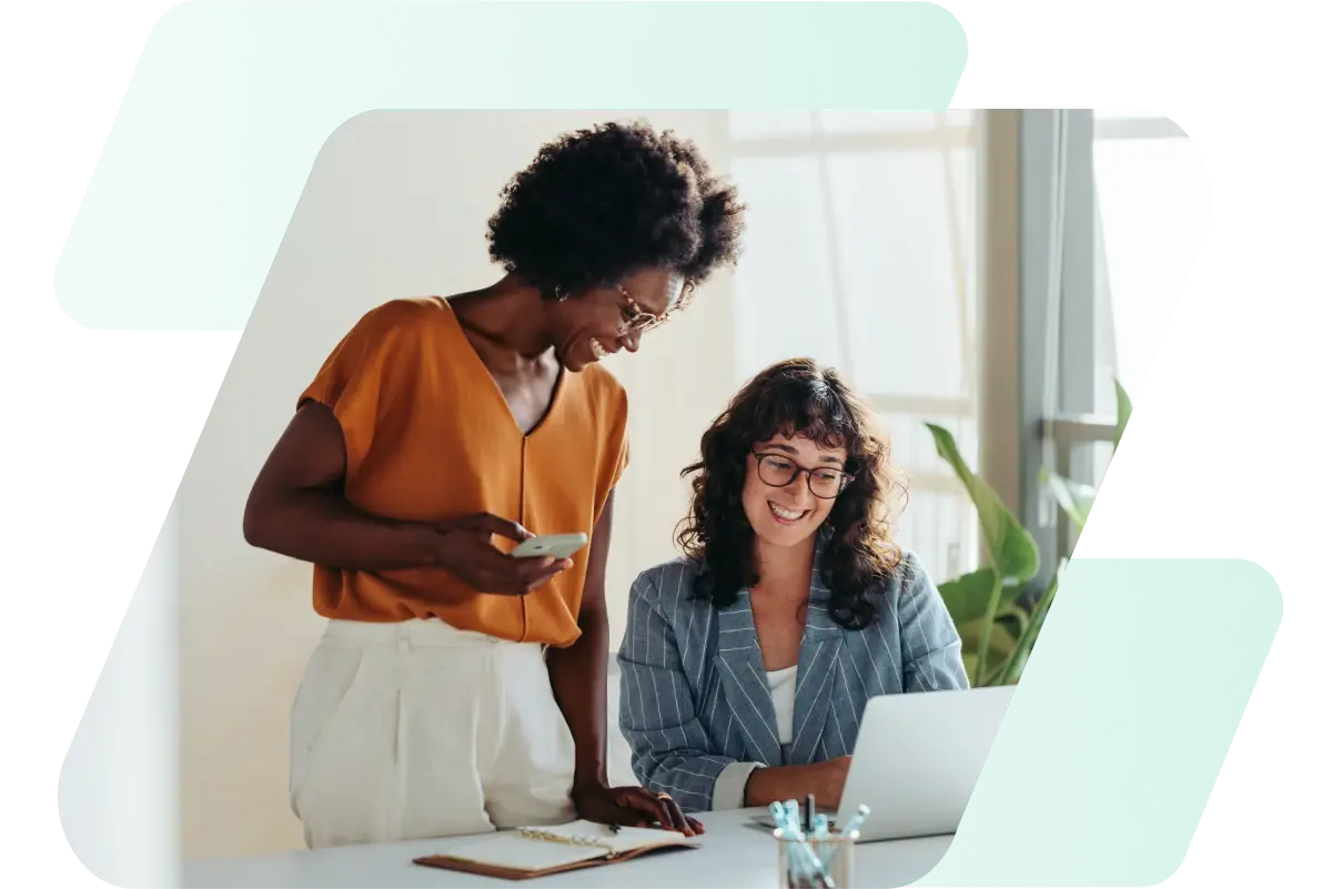 This image shows two women working together with light green and gradient dashes behind the image.