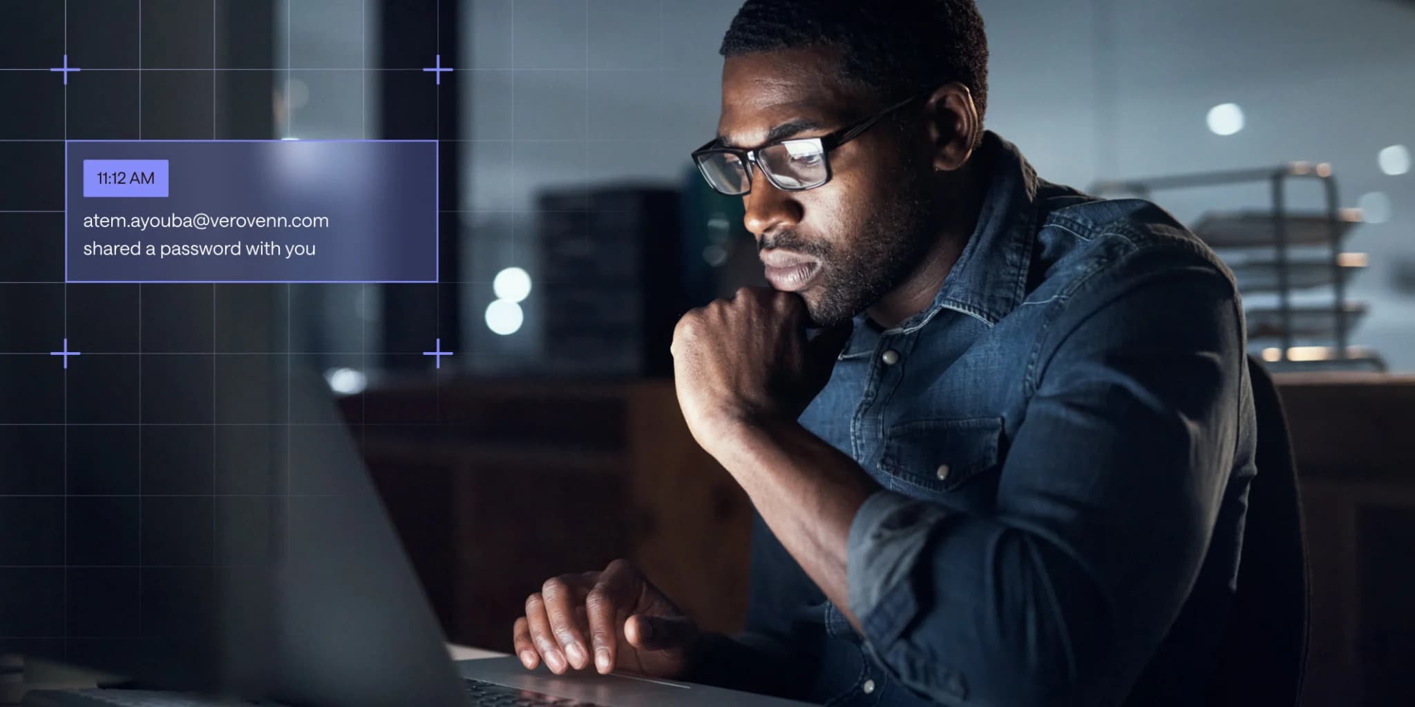 An IT admin works at his computer, checking an overview of his organization’s password security with Dashlane.