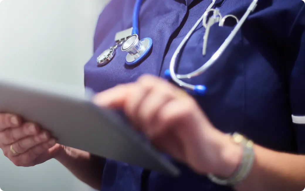 Medical professional working on a tablet.